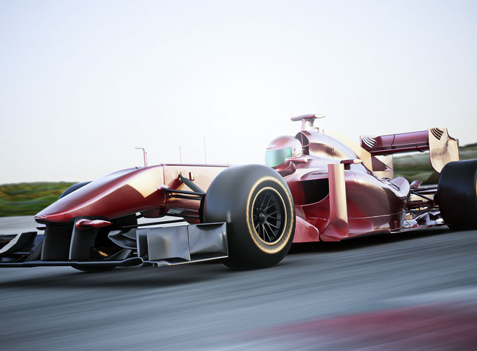 Roter Rennwagen auf einer Rennstrecke – Präzisionsteile von HÖHN im Einsatz für maximale Performance im Motorsport